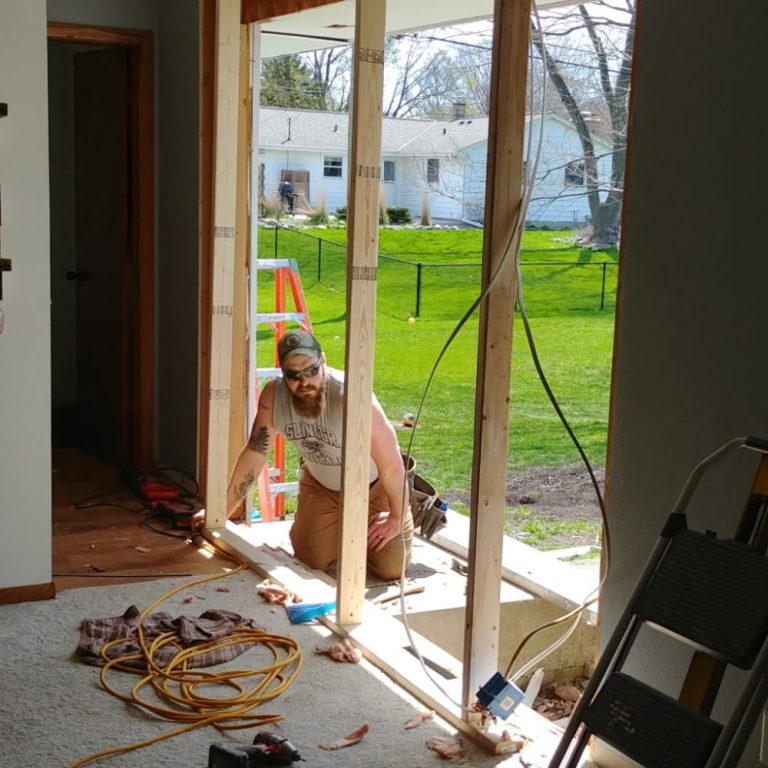 The master craftsman measuring spaces during a sliding door patio project