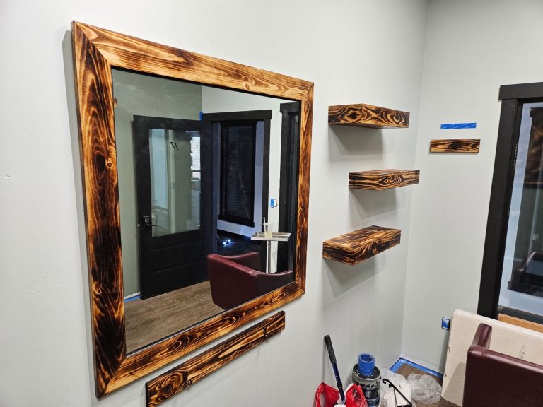 Aesthetics and ergonomics found in this dark wood-stained mirror frame and wood salon shelves