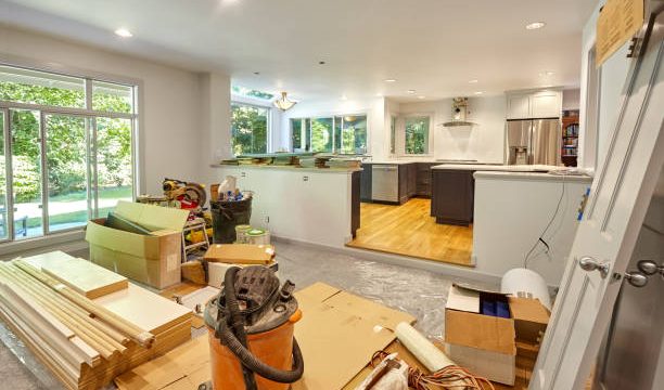 An indoor home improvement project in-progress with wood materials and workspace vacuums for clean-up