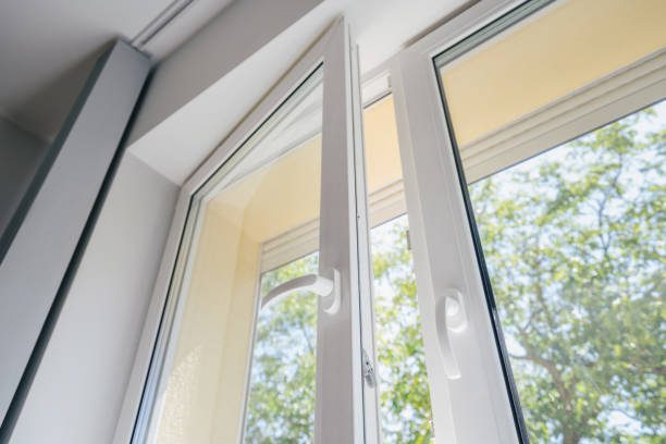 An open window with easy-open handles and sun shining in