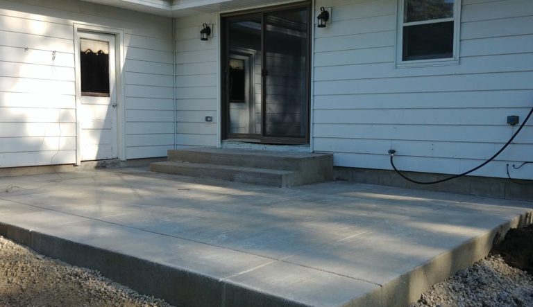 A clean, new safe concrete patio slab with improved sliding door access