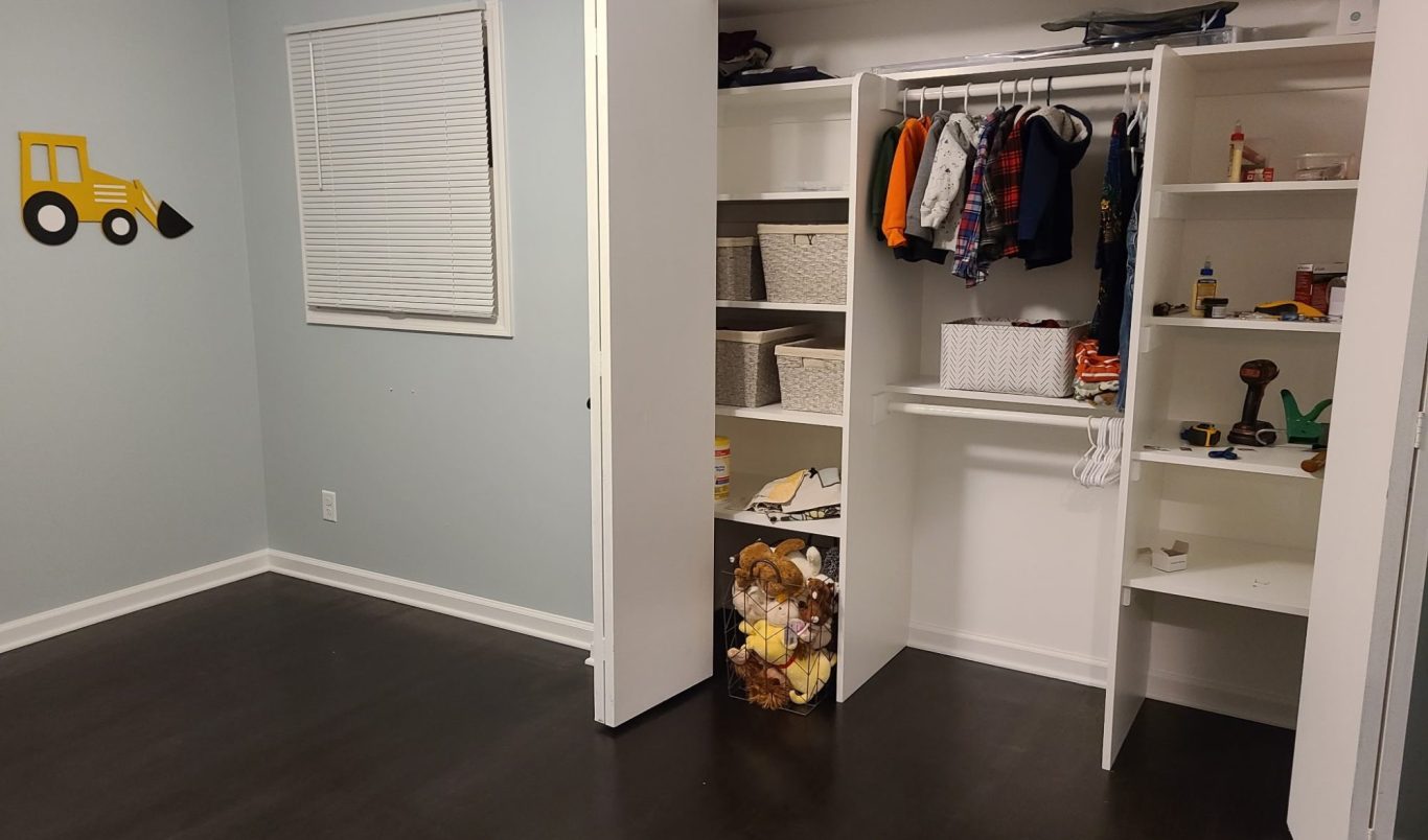 An aesthetic, organized, modern renovated kid's bedroom with newly-installed shelving and trim