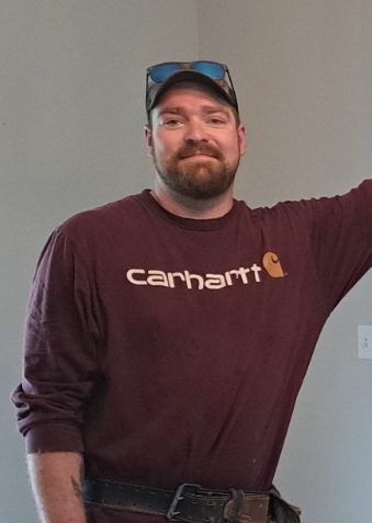A headshot of the master craftsman and Owner upon finishing a functional, decorative piece for a happy customer's dining room area